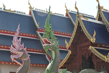 Colorful of Naga statues in Thai art decorate the steps of the ordination hall at Wat Den Sali Si Mueang Kaen temple. Located at Cheng Mai Province in Thailand.