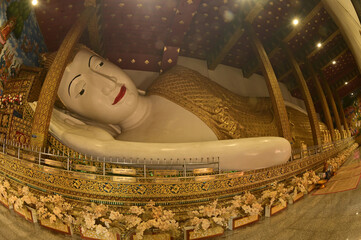 The Reclining white statue Phra Chaeo Nip Phran Buddha is enshrined in a teakwood chapel at Wat Den Sali Si Mueang Kaen temple or Wat Ban Den. Located at Cheng Mai Province in Thailand.