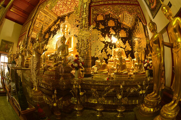 Statues of white Singha, which are animals in Thai art, decorate the front of the Church or Chapel and pagoda at Wat Den Sali Si Mueang Kaen temple. Located at Chaing Mai Province in Thailand.