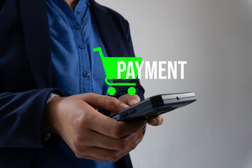 A person holding their phone, which displays a green shopping cart icon and the text 