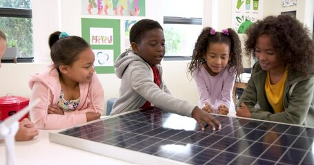 Children exploring solar panel in classroom, learning about renewable energy - Powered by Adobe