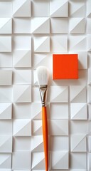 Orange block and white paintbrush on white geometric background