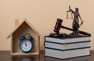 Judge's gavel, alarm clock, Themis figure, Symbolic wooden house and books - conceptual image on...