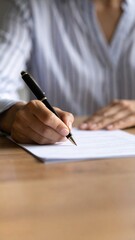 Woman's Hand Writing on Paper with Pen Close Up Shot.