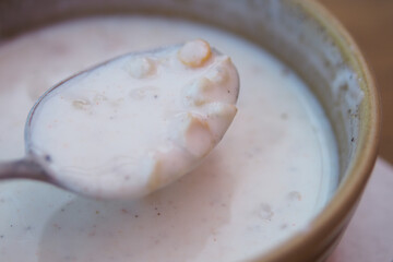 Creamy soup with floating ingredients in a bowl
