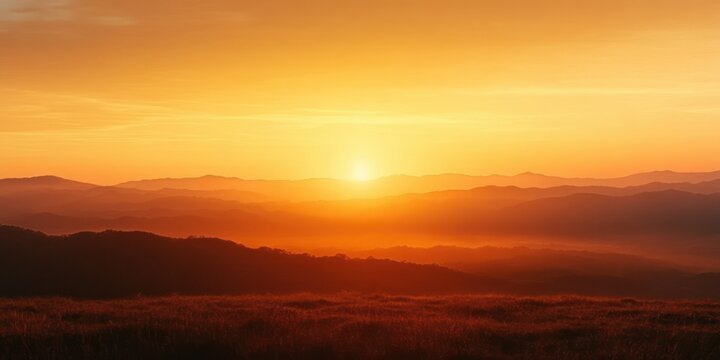 Vibrant orange sunrise over rolling hills and distant mountain ranges with a peaceful and warm atmosphere - Powered by Adobe