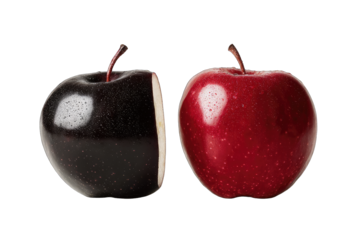 A halved black apple juxtaposed with a whole red apple, both glossy and meticulously presented against a stark black background