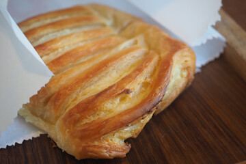 Freshly baked pastry displayed on wooden surface
