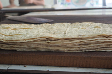 Freshly made tortillas stacked at a market in Mexico