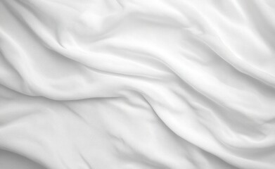 Naklejka premium Close-up of soft, white fabric with gentle folds and natural wrinkles creating a smooth, flowing texture