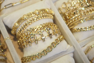 Elegant gold bracelets displayed in a jewelry showcase