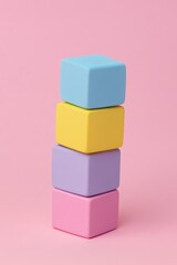 Obraz premium Stacked pastel colored cubes on a pink background