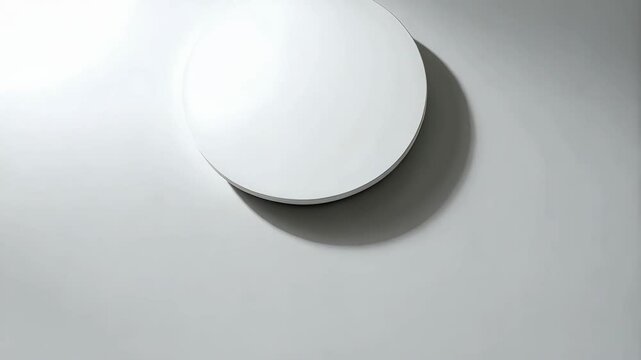 Minimalist white round object on white background, casting shadow, studio shot with bright light and plain design, clean and bright