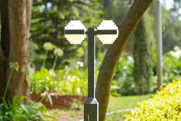Contemporary lamppost design set amidst park greenery.