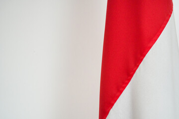 The Indonesian flag flies indoors. The colors of the flag of the Republic of Indonesia are red and white.