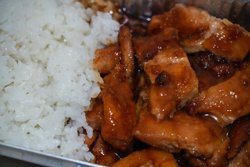 Teriyaki chicken and rice in a food box.