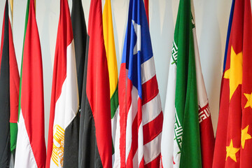 A lineup of international flags, representing Asian and African nations, displayed in commemoration...