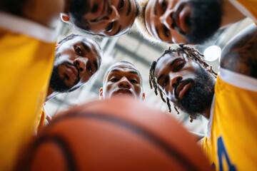 High school basketball team in huddle symbolizing teamwork, support, and game preparation