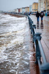 Beach and promenade flooded by sea in a stormy weather
