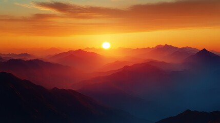 Obraz premium Sunset over a vast mountain range with layers of peaks fading into the horizon under a sky with vibrant orange and red hues