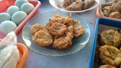Golden-brown Indonesian-style mashed potato fritters, known as perkedel kentang, made from seasoned mashed potatoes mixed with spices and sometimes minced meat, then deep-fried until crispy outside 