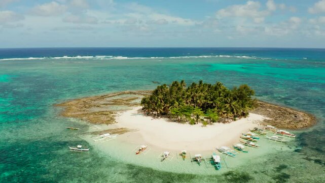 Tropical island with palm tree, beach with tourists and boats. Guyam island, Philippines, Siargao. Summer and travel vacation concept