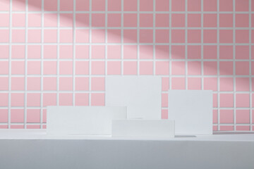 Symmetrical white rectangular podiums placed on a grey platform with soft diagonal lighting. Pink...