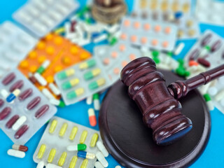 Legal implications of pharmaceutical regulations highlighted by a gavel and assorted medications