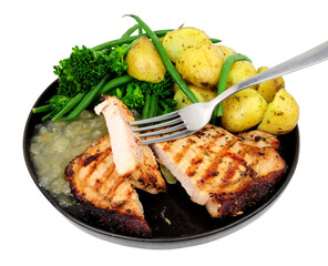 Pepper crusted pork loin steak meal with new potatoes and apple sauce isolated on a white background
