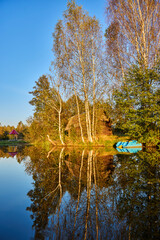Tranquil Reflections: House and Trees Mirrored in River