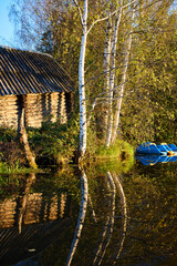 Tranquil Reflections: House and Trees Mirrored in River