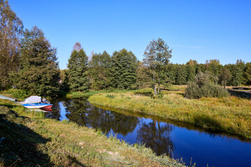 Serene Riverbank Scene with Lush Greenery
