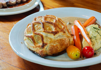 Beef Wellington, fillet steak coated with Pâté and Duxelles, wrapped in puff pastry served with...