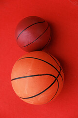 Basketballs on the ground. Close-up of a ball on a red court. Minimalism.