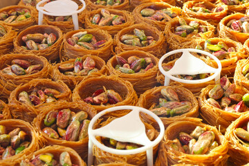 The baklava (a dessert made of thin pastry, nuts, and honey)