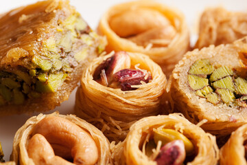 Oriental sweets in shape of nest with nuts close-up