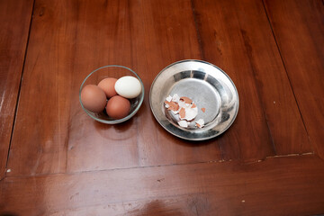 Bowl containing chicken boiled egg and skin egg on plate in the kitchen table, prepares breakfast at home, health care and food concept. Copy space