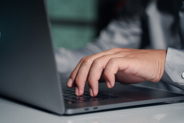 Asian businessman using laptop to calculate business tax and financial data in office