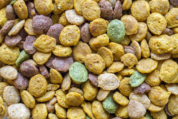 Vitaminized dry pet food. Granulated multi-colored dry food for cats and dogs.