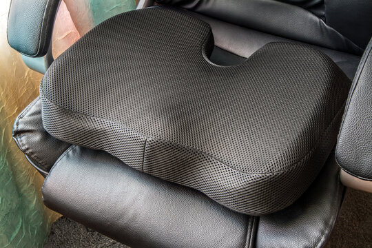 Modern orthopedic chair cushion. Black orthopedic seat cushion made of memory foam.