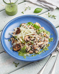 Oat risotto with vegetables, mushrooms and green pesto