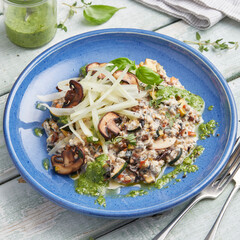 Oat risotto with vegetables, mushrooms and green pesto