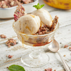 Banana nice cream scoops with caramel sauce and biscuit
