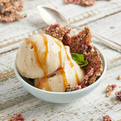 Banana nice cream scoops with caramel sauce and biscuit