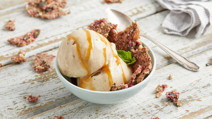 Banana nice cream scoops with caramel sauce and biscuit