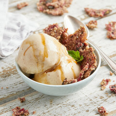 Banana nice cream scoops with caramel sauce and biscuit