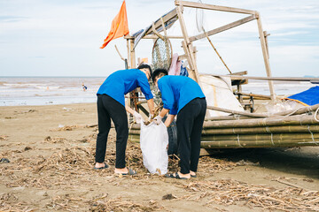 Volunteers clean up the beach while promoting environmental awareness during a coastal cleanup...