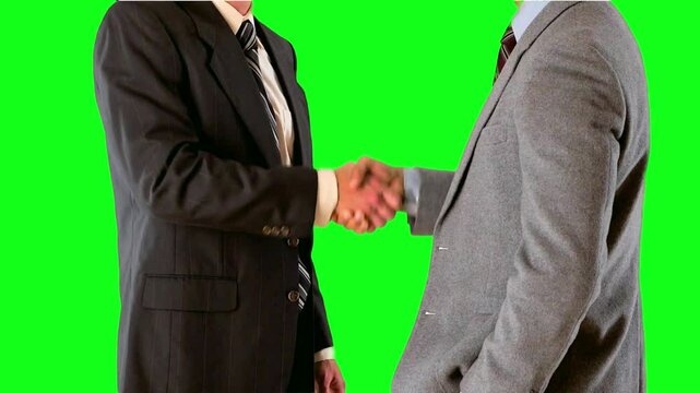 4K Video of Two Businessmen Shaking Hands in Modern Office on a Solide Green Background - Professional Corporate Stock Footage