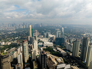 Aerial view of high rise buildings and residential towers in Makati City. Metro Manila, Philippines.