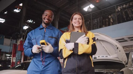 Happy professional teamwork, White female inspector engineer and Black mechanic man cheerful, arms crossed with smile in fix car garage, maintenance service jobs in automotive transportation industry. - Powered by Adobe